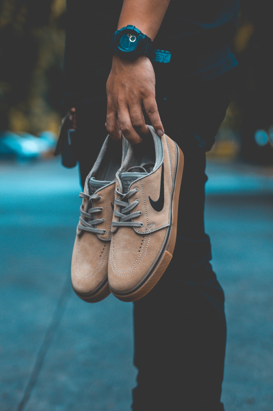 Shoes held by their laces, from the original Firm website